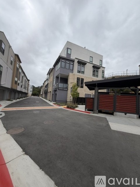 A street view of a residential area with modern buildings.