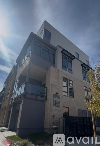 A modern building with a balcony and a sign that says "avail".
