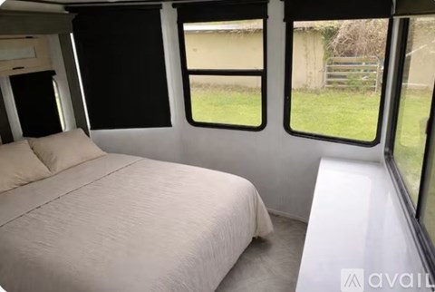A bedroom with a bed and a window seat.