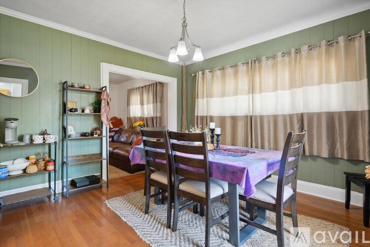 A dining room with a table set for four.