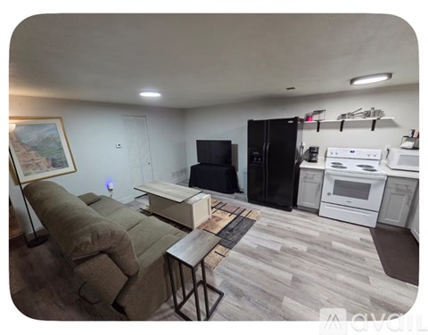 A kitchen with a refrigerator, oven, and microwave.
