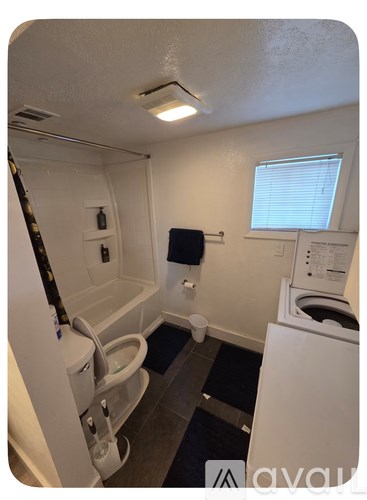 A small bathroom with a toilet, sink, and bathtub.