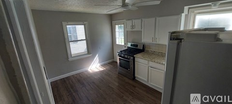 A kitchen with a stove top oven and a refrigerator.
