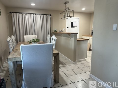 A dining room with a table and chairs.
