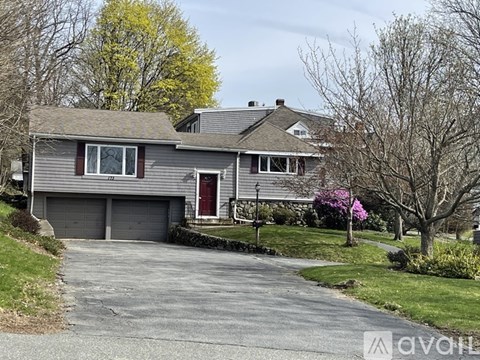 A two-story house with a garage and a driveway.