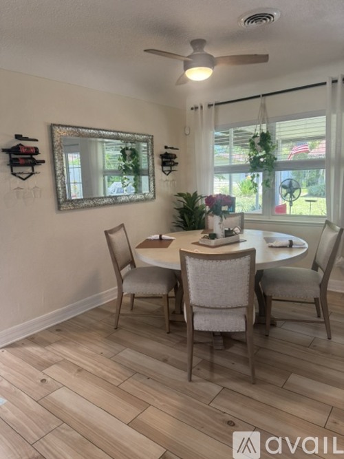 A dining room with a table and chairs.