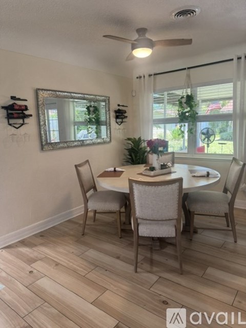 A dining room with a table and chairs.