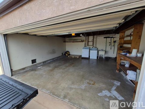 A garage with a concrete floor and a white wall.