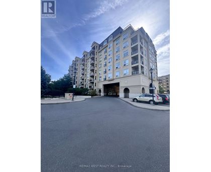A large apartment building with a parking lot in front.