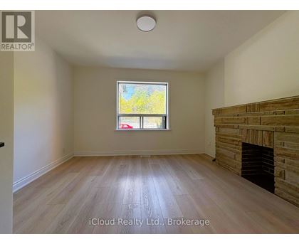 A room with a fireplace and a window.