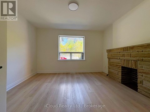 A room with a fireplace and a window.