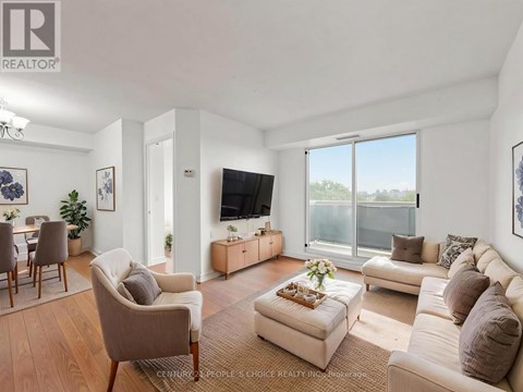 A living room with a couch, chairs, and a television.