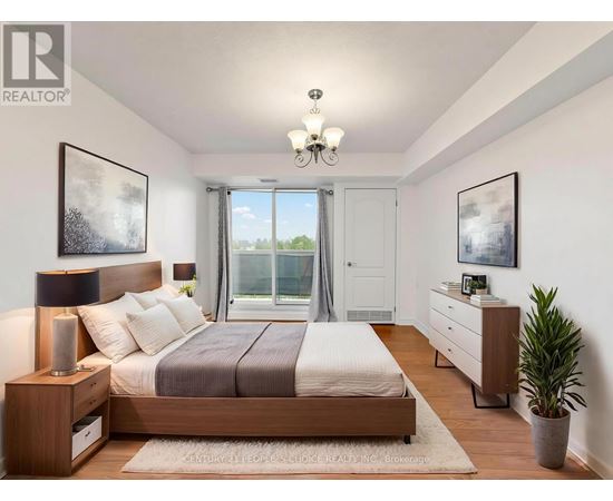 A bedroom with a large bed, a nightstand, and a plant.
