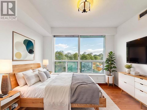 A bedroom with a large bed and a flat screen TV.