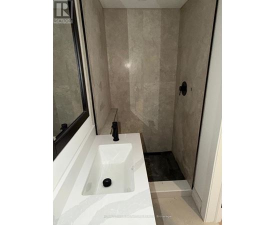 A bathroom with a sink and a shower.