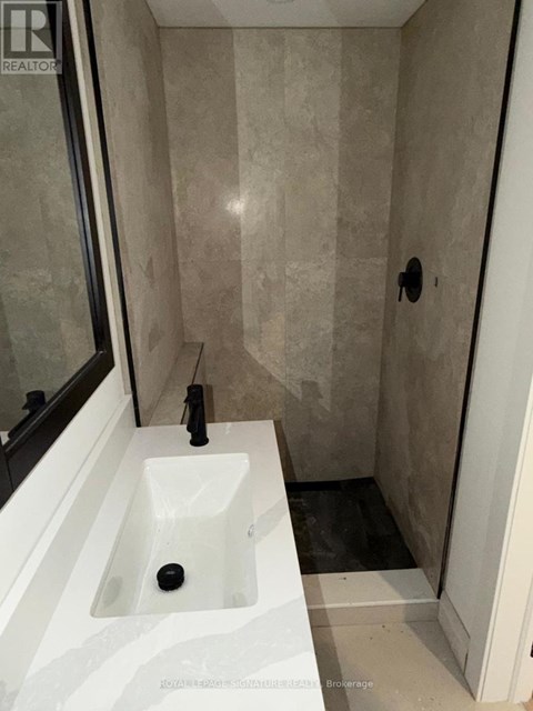 A bathroom with a sink and a shower.