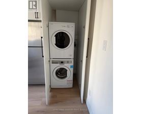 A white washer and dryer in a small room.