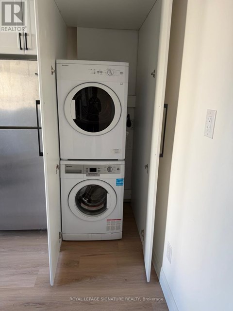 A white washer and dryer in a small room.