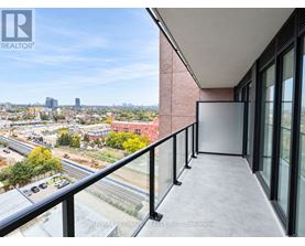 A balcony with a view of a cityscape and construction.