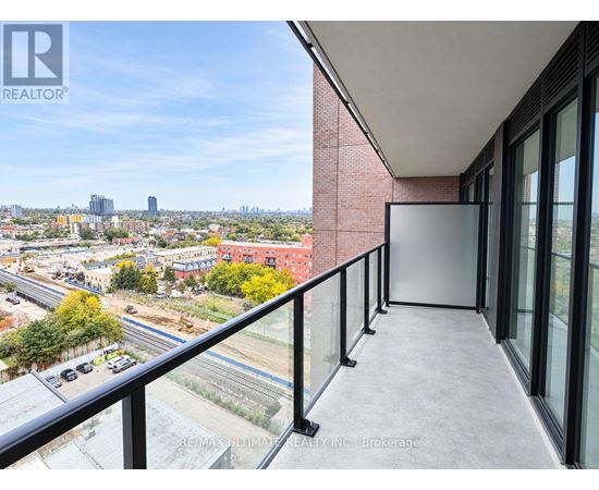 A balcony with a view of a cityscape and construction.