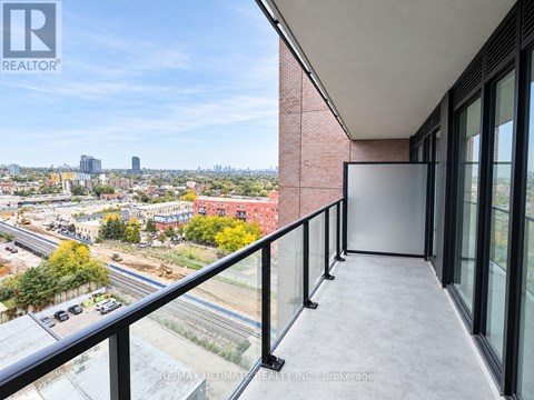 A balcony with a view of a cityscape and construction.
