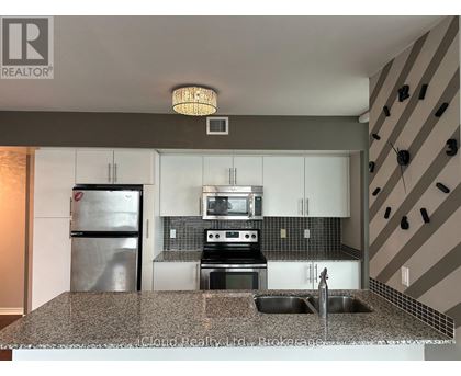 A modern kitchen with granite countertops and stainless steel appliances.