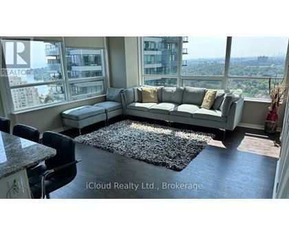 A living room with a large window overlooking a cityscape.