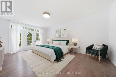 A bedroom with a large bed and a green blanket.