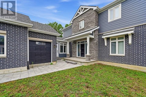 A house with a brick exterior and a large front yard.