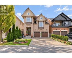 A large, well-maintained house with a driveway and landscaping in front.