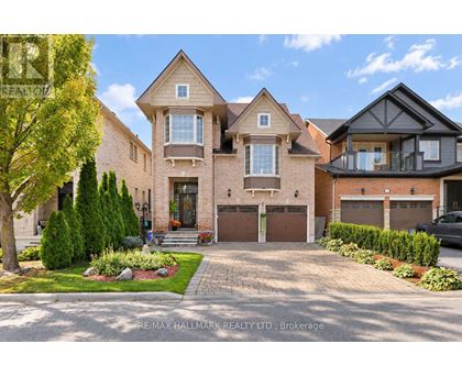 A large, well-maintained house with a driveway and landscaping in front.