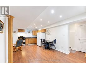 A kitchen with a dining table and chairs.