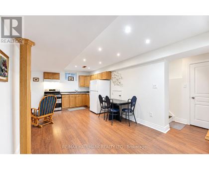 A kitchen with a dining table and chairs.
