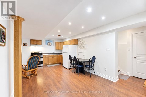 A kitchen with a dining table and chairs.