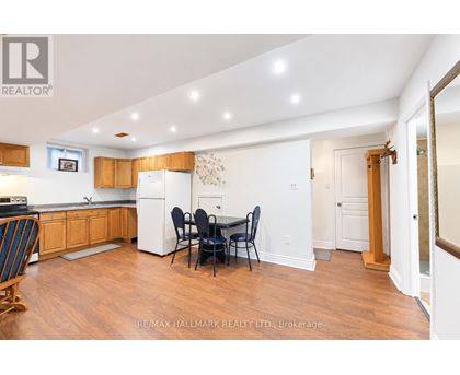A kitchen with wooden floors and white walls.