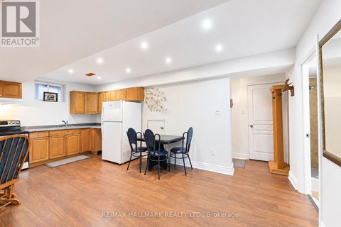 A kitchen with wooden floors and white walls.