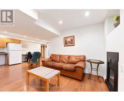 A living room with a brown leather couch and a wooden coffee table.