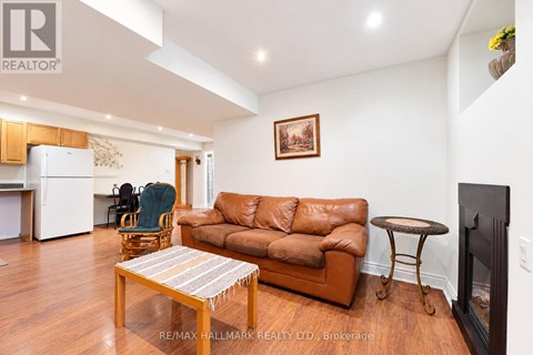 A living room with a brown leather couch and a wooden coffee table.