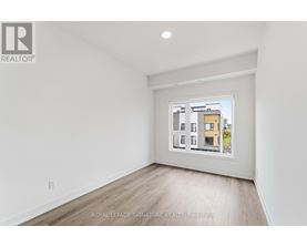 A white room with a picture of a building on the wall.