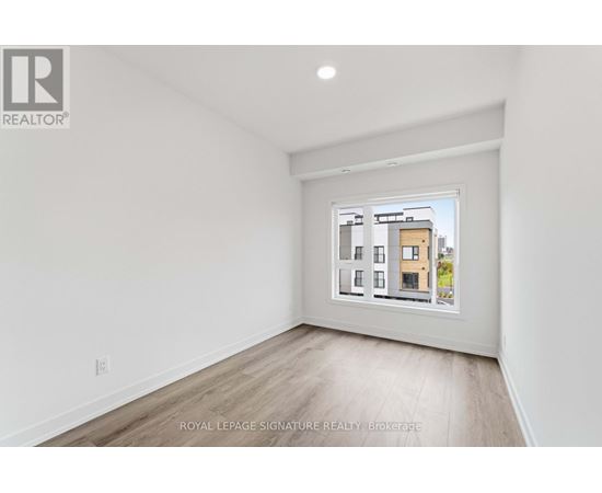 A white room with a picture of a building on the wall.