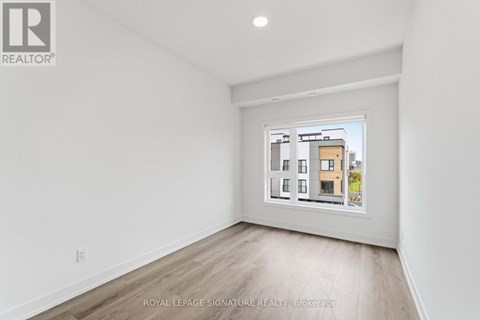 A white room with a picture of a building on the wall.