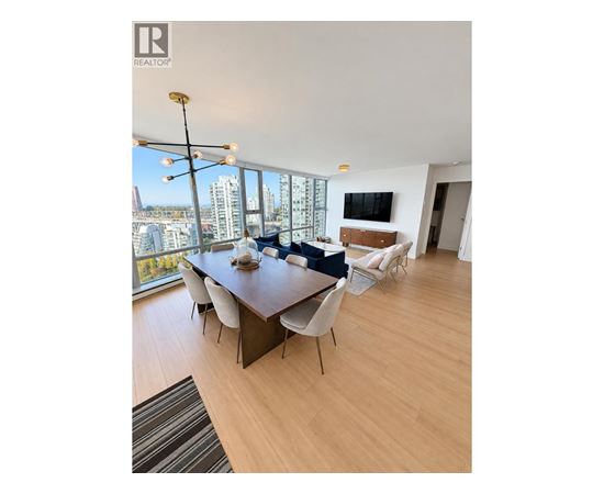 A modern dining room with a long table and chairs.