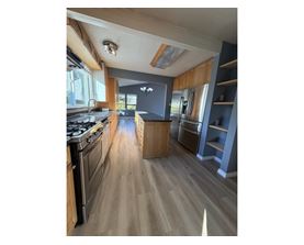 A kitchen with a stove top oven and a counter top.