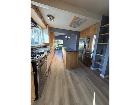 A kitchen with a stove top oven and a counter top.