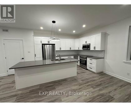 A modern kitchen with white cabinets and a central island.