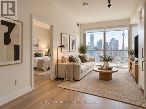 A living room with a view of the city skyline.