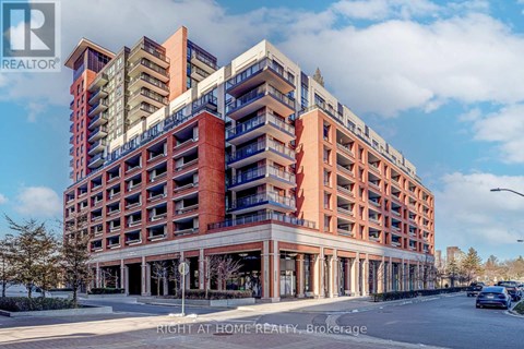 A multi-story apartment building with a parking lot in front.