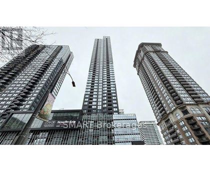 A tall building with the words "Now On Smart" on the side.