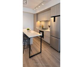 A modern kitchen with a table and chairs.