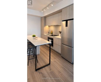 A modern kitchen with a table and chairs.